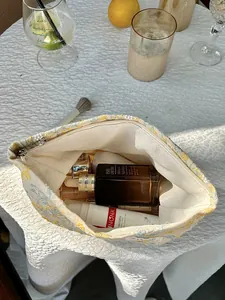 View inside the floral embroidered makeup bag showing large storage capacity for cosmetics