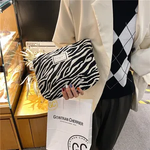 Detail view of zebra pattern embossed makeup bag with a stylish fabric texture
