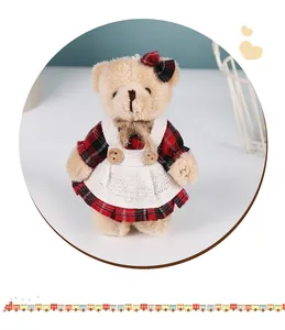 Adorable small plush bear keychain pendant wearing a red plaid dress and white linen apron