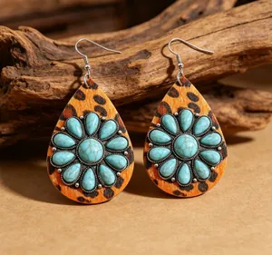 Detail of Western style teardrop earrings with leopard print and turquoise stones.