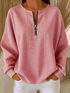 Red and white striped long-sleeve top featuring drop shoulders and a front O-ring half-zipper.