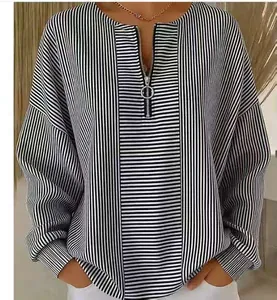 Casual women's black and white striped long sleeve top with zipper neckline detail