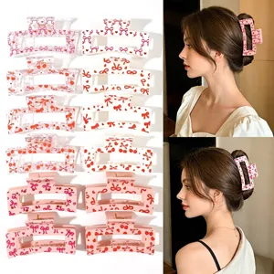 Stylish hair claw clips with bow and heart patterns, featuring model demonstration