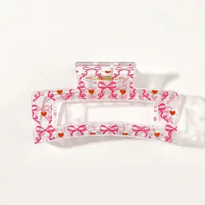 Transparent rectangular hair claw clip with pink bows and red hearts print detail view