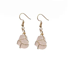 Handmade raw pink crystal earrings with elegant gold wire wrapped design for healing