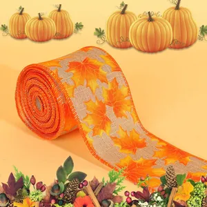 Roll of natural burlap ribbon with orange maple leaf patterns for autumn harvest decor