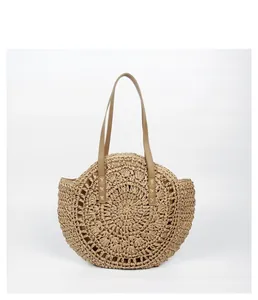 Handmade Bohemian round straw woven beach tote bag featuring durable shoulder straps