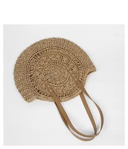 Detailed top view of a bohemian round straw bag with woven texture and leather straps