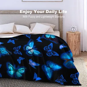 Soft flannel blanket with dreamlike blue butterfly print on black background
