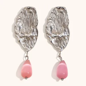 Elegant stainless steel ocean-themed drop earrings with textured pink teardrop stone