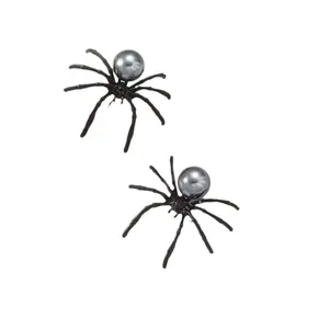 Close-up of gothic Halloween spider earrings with black pearl on a white background.