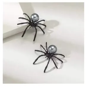 Detail showing spider-shaped earrings with unique grey pearl accents