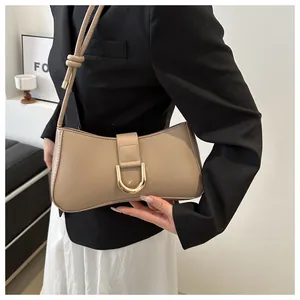 Elegant beige French design underarm bag with a stylish gold D-buckle closure.