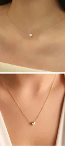 Primer plano detallado de collares dorados minimalistas con colgantes de corazón y circón