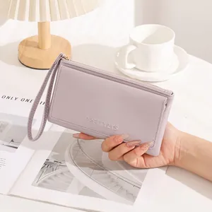 Detail view of a minimalist lavender women's long wallet with elegant wristlet strap.