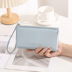 Minimalist light blue long wallet for women with wrist strap and embossed brand detail