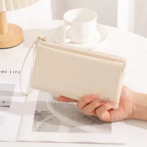 Elegant creamy white minimalist long wallet for women featuring a functional wrist strap detail