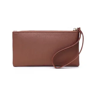 Detailed view of brown leather texture ladies long wallet wristlet with gold zipper
