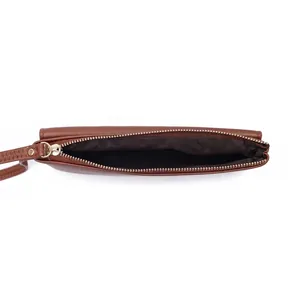 Close-up of the metal zipper and interior lining of this brown long leather wallet for women.