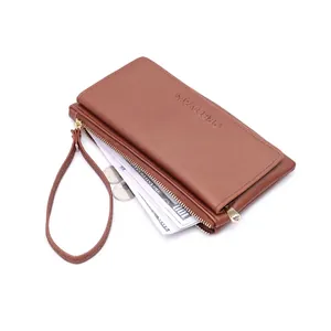 Detail of brown faux leather long wallet showing large capacity with cash and coins