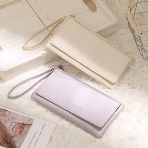 Detail view of two minimalist long wallets in cream and lavender with wrist straps