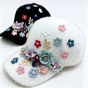 Macro detail of plush winter baseball cap featuring 3D floral embroidery and rhinestones.