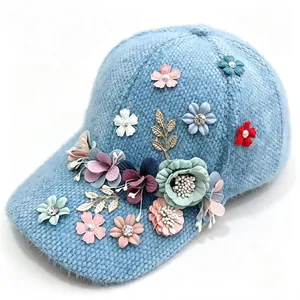 Plush light blue baseball cap featuring colorful 3D floral and rhinestone accents