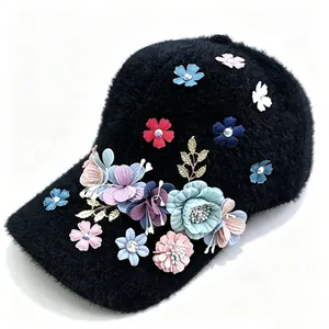 Close-up of black fuzzy baseball cap with colorful 3D flower and rhinestone decorations