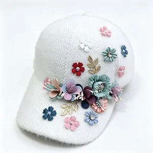 Close-up detail of plush fabric texture and colorful floral embellishments on baseball cap
