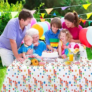 Detailed shot of a colorful star-patterned disposable PE tablecloth at a birthday party.