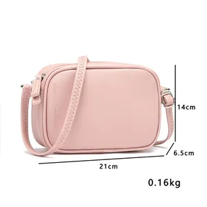 Detailed view of pink PU leather crossbody bag showing 21x14x6.5cm dimensions and weight.