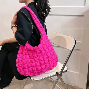 Vibrant pink bubble textured shoulder bag for women styled in a minimalist room