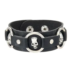 Punk style black faux leather bracelet with silver skull charms and decorative rivets jewelry