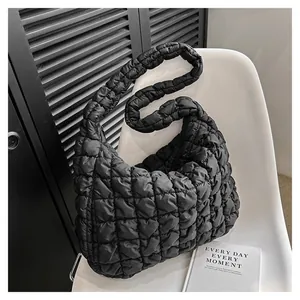 Modern black quilted puffy grid shoulder bag with a minimalist design for women