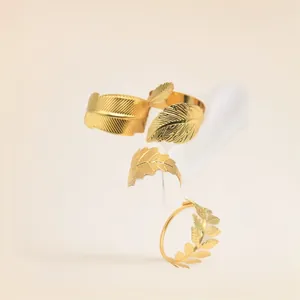 Close-up of elegant gold leaf metal napkin rings for festive party table settings