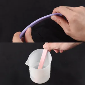 Close-up showing the flexibility and actual usage of reusable silicone resin stirring rods