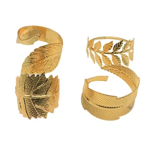 Set of four golden leaf metal napkin rings for elegant party table settings and decor