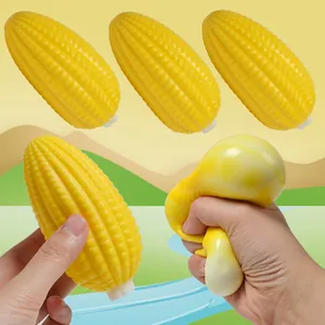 Realistic yellow corn-shaped squishy stress relief toy being squeezed by hand for decompression