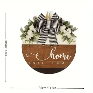 Detailed view of the 30cm round wooden Sweet Home door sign with a striped bow.