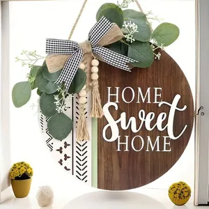 Detailed view of Home Sweet Home wooden door sign with eucalyptus and checkered bow