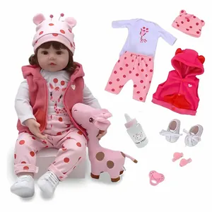 Magnifique poupée bébé reborn 55 cm avec tenue à pois roses et girafe en peluche