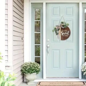 Rustic Home Sweet Home wooden door sign hanging on a stylish light blue front door