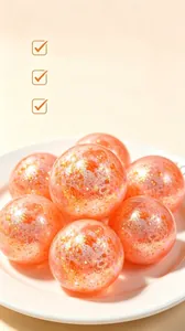 Close-up showing the translucent texture and golden glitter of the orange stress balls