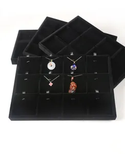 Stacking black velvet jewelry display trays with multiple organizers for necklaces and rings
