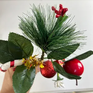 Detailed view of Christmas pick with pine needles, red berries, and festive bauble