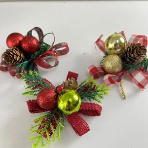 Close-up of festive Christmas bow ornaments with pine needles, pine cones and colorful balls