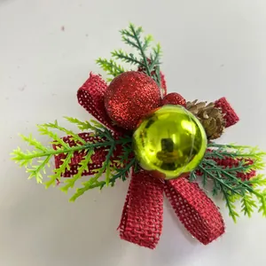Detailed shot of Christmas decoration with red burlap bow, faux pine needles and baubles