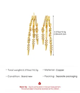 Detail view of irregular gold tassel earrings with zirconia and spike accents
