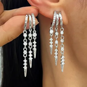 Detail view of silver-tone tassel hoop earrings with sparkling zircon and spikes