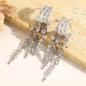 Macro view of silver-toned hoop earrings with sparkly zircon tassels and spikes